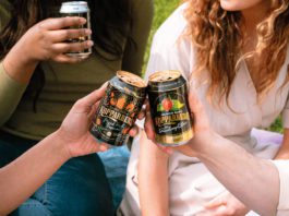 Sweet tastes for the summer people "cheersing" cans of Kopparberg