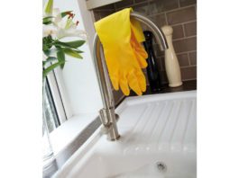 Shop for the future rubber gloves resting over a tap