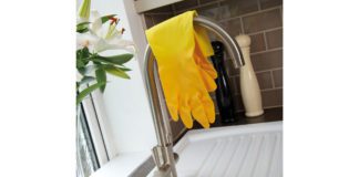 rubber gloves resting over a tap