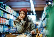 woman thinking in a grocery store