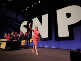 We’ll still push for our causes Nicola Sturgeon walking across stage with SNP in large letters