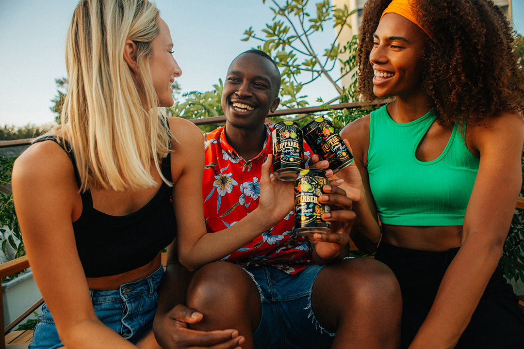 People clinking cans of the new Kopparberg Summer Punch variant