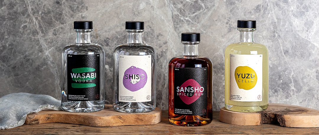 The Wasabi Company range of drinks set against a grey background; Wasabi Vodka, Shiso Gin, Sansho Spiced Rum and Yuzucello