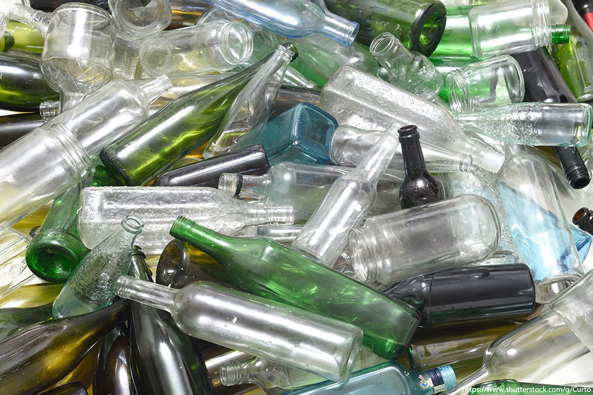 Large pile of glass bottles to be recycled.