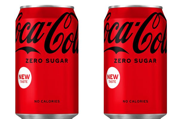 Two cans of Coca-Cola Zero Sugar stand next to each other against a white background.