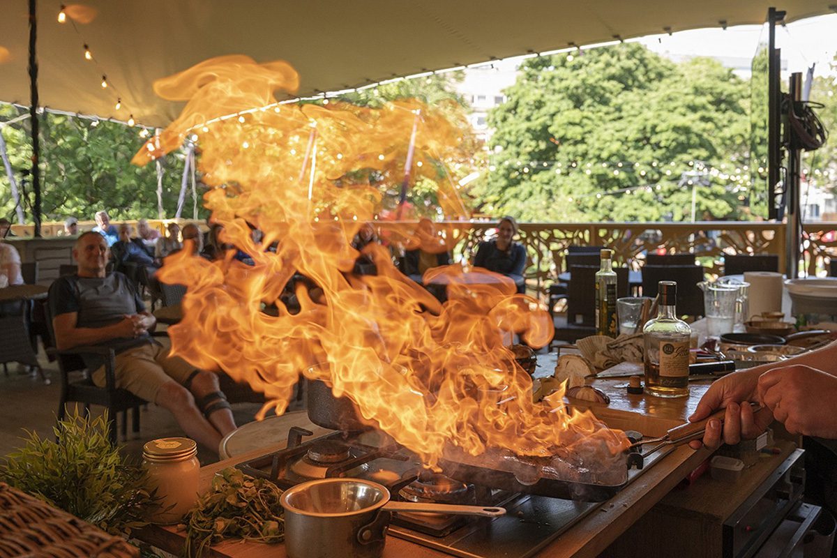 A fire in a frying pan as food is prepared for the entertainment of the guests in attendance.