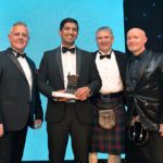 Awards Profile – Industry Achievement Harris Aslam is congratulated by Republic Technologies UK sales and marketing director Gavin Anderson, magazine editor Giles Blair and event host Craig Hill at the Scottish Grocer Awards 2022 in Glasgow.