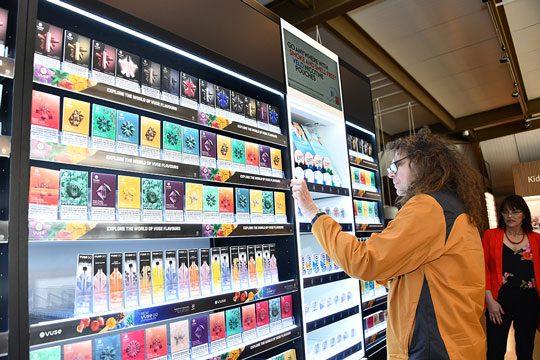 Customer examines the alternative nicotine range provided by British American Tobacco in the firm's new sustainable gantry.