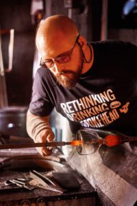 Elliot Walker, Blown Away series 2 winner, works on crafting a new glass for Smokehead whisky.