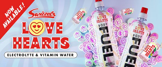 Advert for the new BodyFuel Love Hearts with two bottles of the new drink on top of a pile of Love Hearts candy heart sweets.