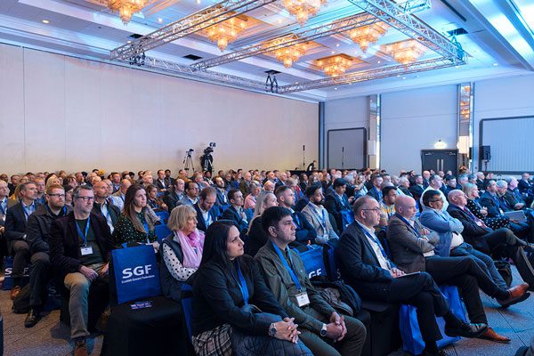 A crowded room of people attending the SGF Annual Conference in 2022. They are all sitting down.