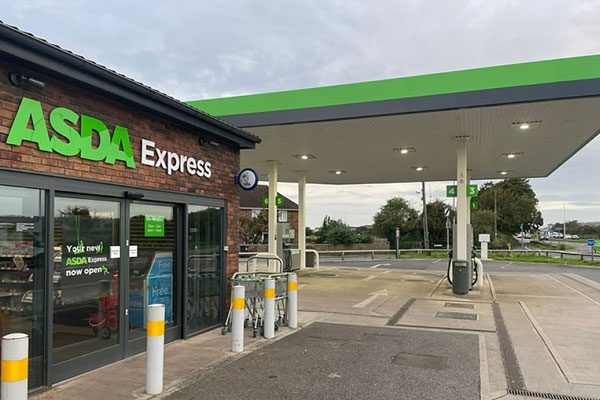 An Asda Express forecourt site with redstone brickwork for the convenience store and glass automatic doors.