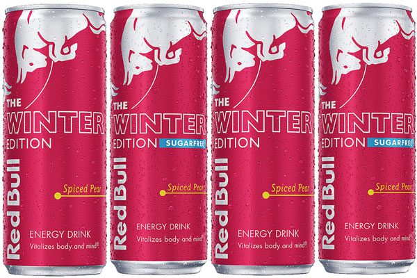 Four cans of Red Bull The Winter Edition are in a row. Each features a light red colour with a silver bull design at the top of the can. The second and fourth cans are also sugar free which is highlighted on the cans.