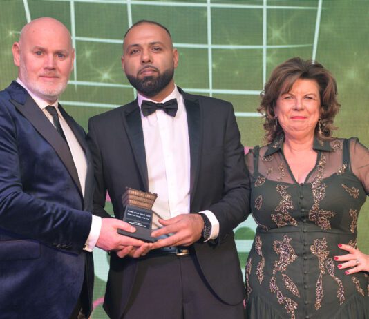 Awards Profile – Independent Retailer of the Year Shajaz Ali is congratulated by Booker Group retail development controller Barry Forbes and 2023 awards host Elaine C Smith.