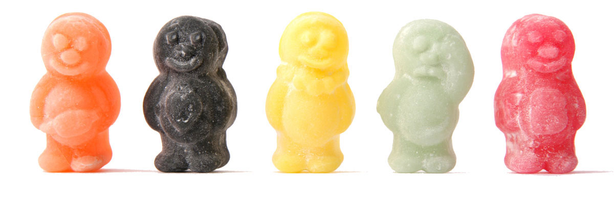 Picture of five different flavoured Jelly Babies standing.