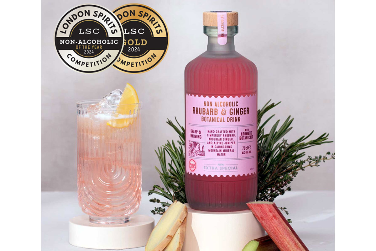 A bottle of Asda Extra Special Non Alcoholic Rhubarb & Ginger Botanical Drink sits on a table next to a drink serve using the non-alc spirit with ingredients from the drink around the bottle.