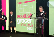 Graham Watson accepts the top Industry Achievement accolade at the Scottish Grocer Awards in 2023.