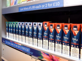 A row of Blu Bar disposable vapes in a gantry.