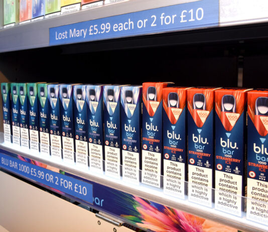 ScotGov announces disposable vape ban delay A row of Blu Bar disposable vapes in a gantry.