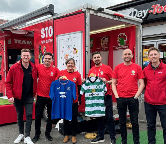 Kellanova kicks off football camps campaign The Kellanova team with the Kellogg's-branded "changing room" van during their visit to Scotland.