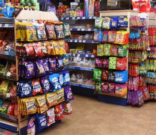 Inflation hits key Bank of England target A store's confectionery section displaying a range of hanging bag sweet brands.