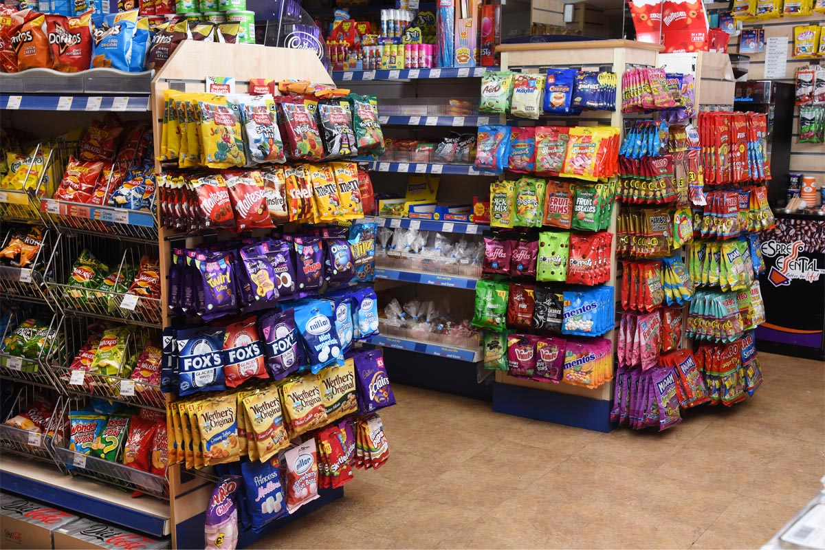 A store's confectionery section displaying a range of hanging bag sweet brands.