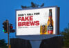 New marketing material for Estrella Galicia beer on a billboard with a slogan that states 'Don't Fall for Fake Brews'.