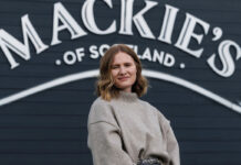 Kirsten Blockley, national account manager at Mackie's of Scotland, stands in front of the Mackie's of Scotland sign.
