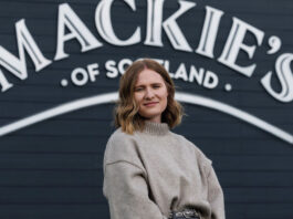 Mackie’s fires up frozen sales Kirsten Blockley, national account manager at Mackie's of Scotland, stands in front of the Mackie's of Scotland sign.