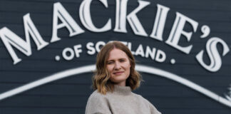 Kirsten Blockley, national account manager at Mackie's of Scotland, stands in front of the Mackie's of Scotland sign.