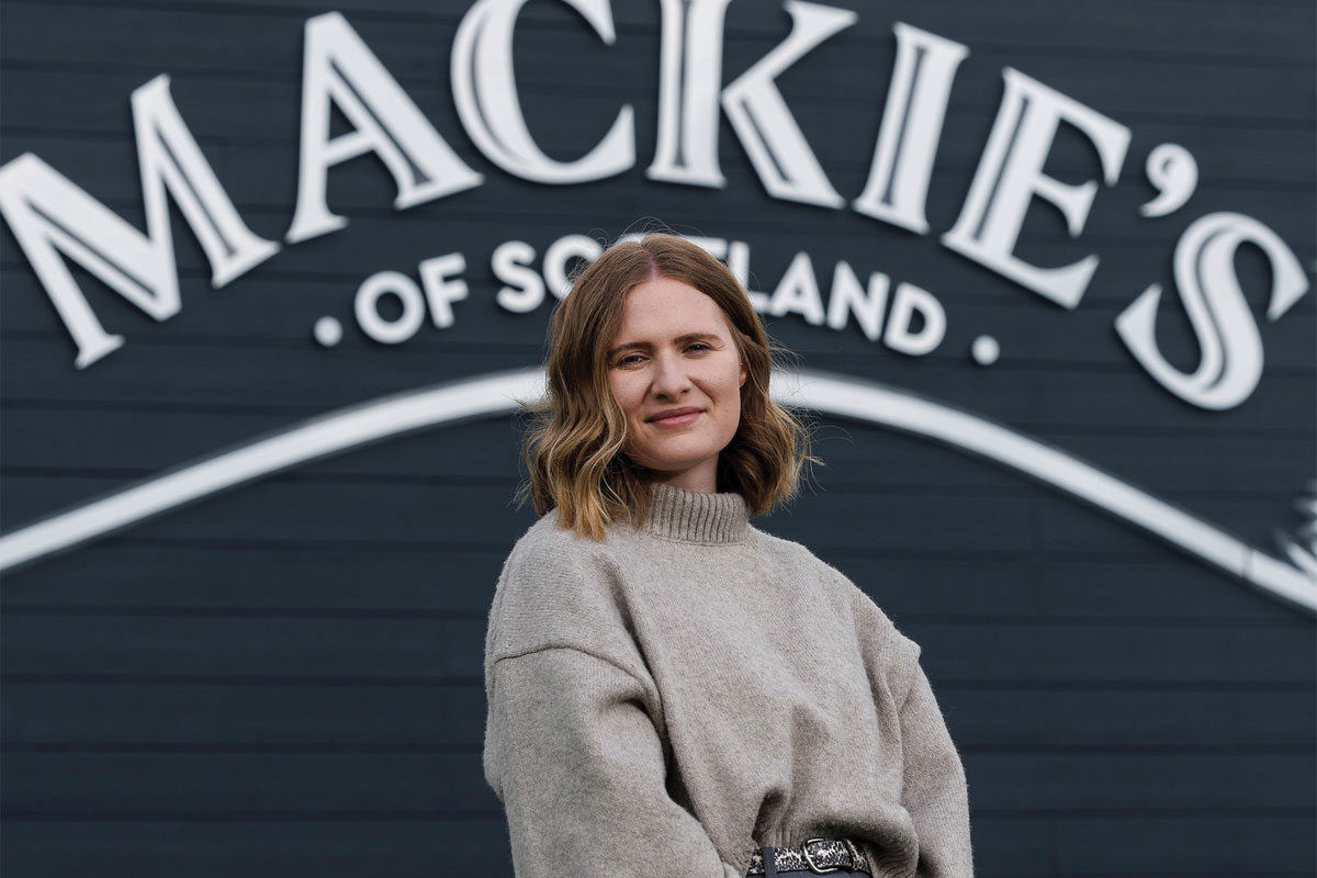 Kirsten Blockley, national account manager at Mackie's of Scotland, stands in front of the Mackie's of Scotland sign.