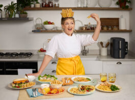 McCain boosts air fryer range with foodie influencer Social media influencer Poppy O'Toole stands wearing a crown made of chips in front of food dishes containing McCain's Air Fryer range.