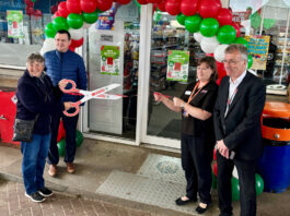 Spar Nairn sees a legacy reopening Reopening of Spar Nairn forecourt with red and green balloons over the door as a group of four people stand around the entrance with one of them holding large, novelty scissors to cut the ribbon.