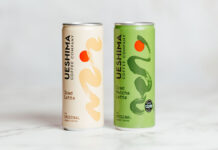 Ueshima Coffee Latte cans stand on a marble table with the Latte variant on the left and Matcha Latte on the right.