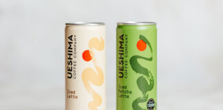 Ueshima Coffee Latte cans stand on a marble table with the Latte variant on the left and Matcha Latte on the right.