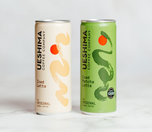 Ueshima Coffee rolls with a Latte innovations Ueshima Coffee Latte cans stand on a marble table with the Latte variant on the left and Matcha Latte on the right.
