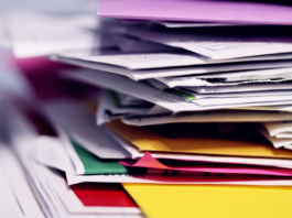 Multi-site supermarket water: efficient payment options Stack of supermarket water bills on desk.