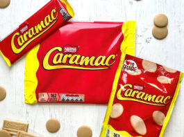 Caramac is back on the shelves Packs of Caramac including a bar, multipack of bars and sharing pack, sit on a white wooden background with pieces of the blonde chocolate around them.