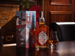 Eden Mill marks hometown pride in new whisky A bottle of Eden Mill Art of St Andrews whisky sits next to a nosing glass and the outer packaging for the dram on top of a wooden table.