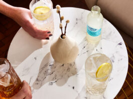 Franklin & Sons adapts to changing tastes Drinks sit on a white marble table with a bottle of Franklin & Sons Sicillian Lemon on the table next to a vase.