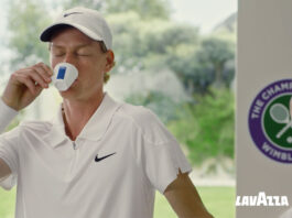 Lavazza takes to centre court in Wimbledon campaign Jannik Sinner drinks from a Lavazza branded espresso cup with the Wimbledon logo behind him and the Lavazza logo in the bottom right corner.