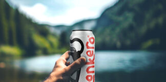 A person holds a can of Lonkero with a blurred out lake in the background.