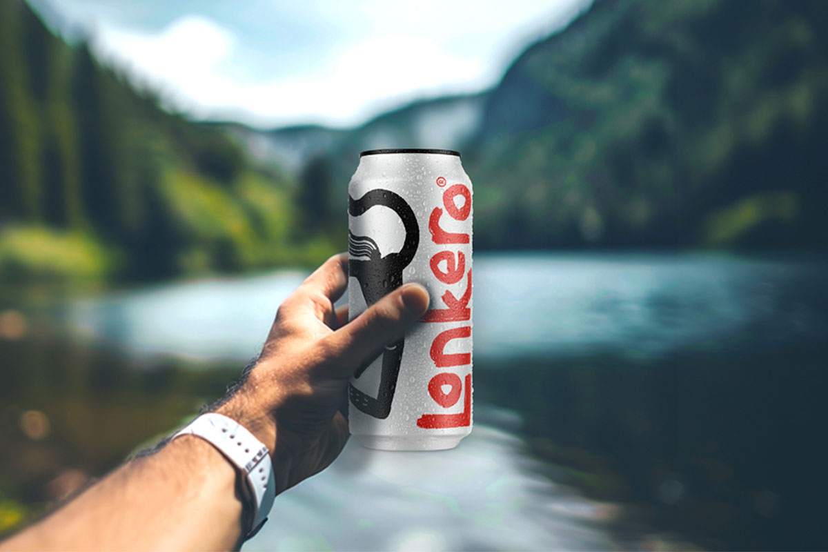 A person holds a can of Lonkero with a blurred out lake in the background.