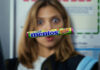 A pack of Mentos Discovery floats in front of a woman's face who is interested in the sweet.
