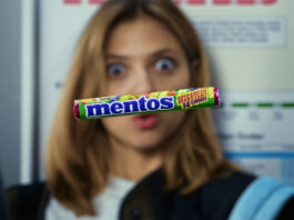 Mentos bolsters Discovery launch in new campaign A pack of Mentos Discovery floats in front of a woman's face who is interested in the sweet.