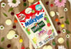 Pack of Milkybar Rowntree Jelly & Ice Cream sweets sits on a wooden table with the sweets around the packet.