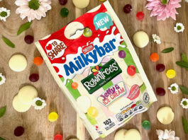 Pack of Milkybar Rowntree Jelly & Ice Cream sweets sits on a wooden table with the sweets around the packet.