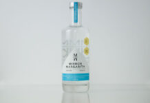 A bottle of Mirror Margarita stands against a white backdrop.