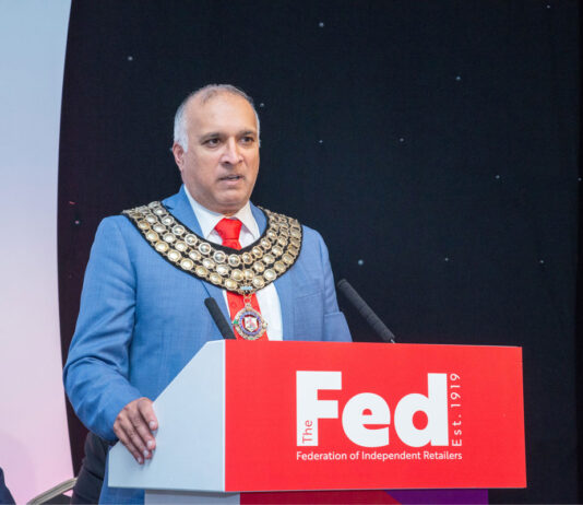 The Fed weighs in on Circular Economy bill Mo Razzaq stands at a podium with The Fed logo on it.