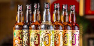 Bottles of Old J Rum range are lined up with a bar background.